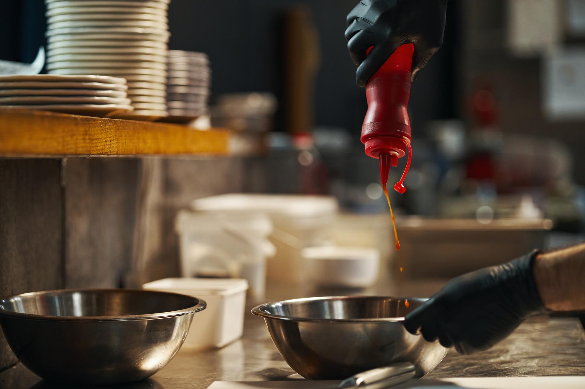Chef demonstrating sauce reduction